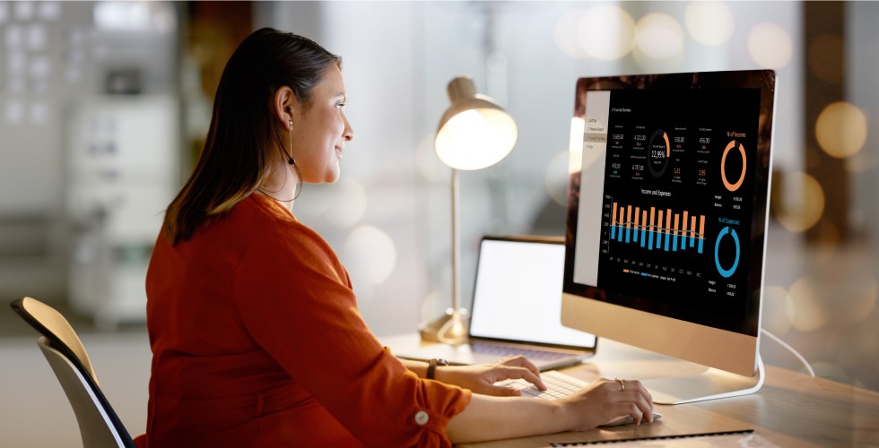 Woman looking at graphs on computer