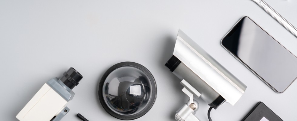 A collection of various electronic security devices displayed on a table.