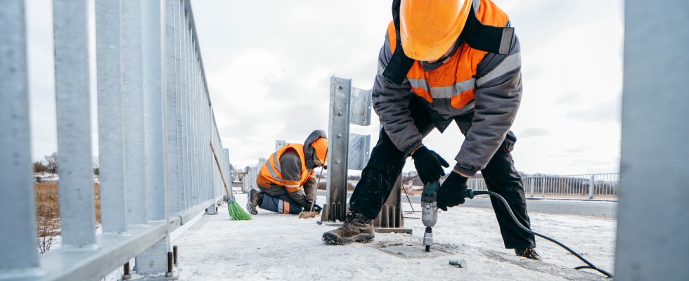 Construction workers collaborating on a site, engaged in various tasks to build and develop infrastructure.