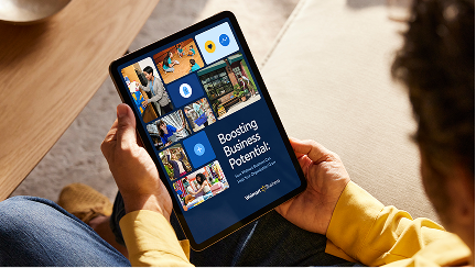 Person reading a PDF on an iPad, showcasing a guide from Walmart Business titled Boosting Business Potential.