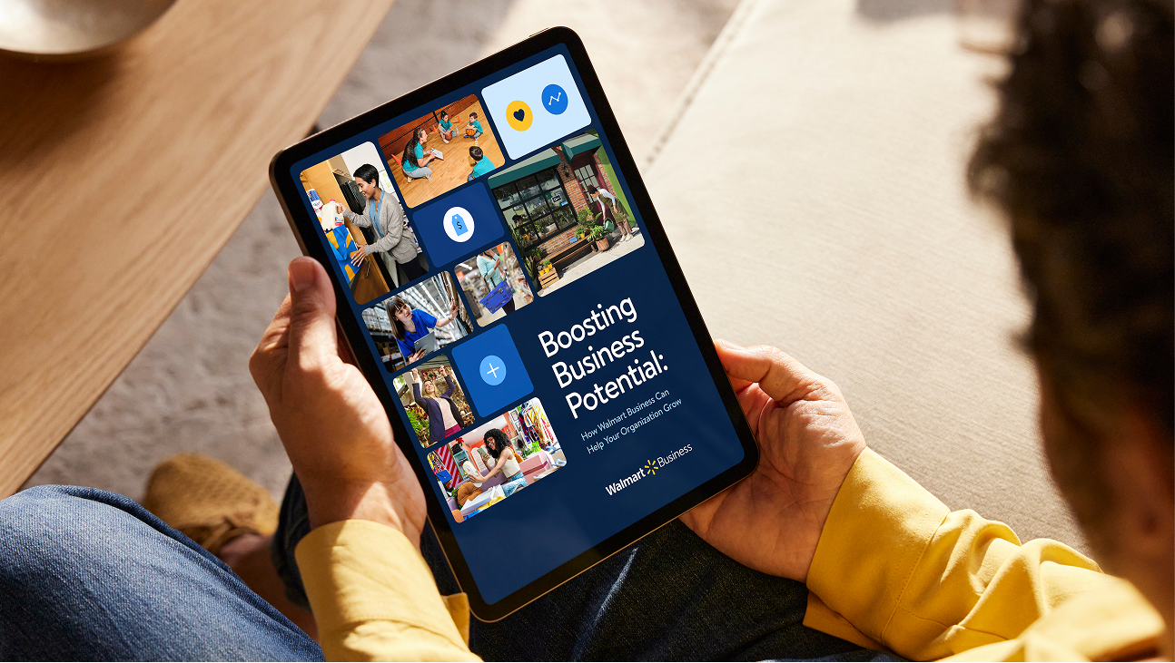 Person reading a PDF on an iPad, showcasing a guide from Walmart Business  titled Boosting Business Potential.