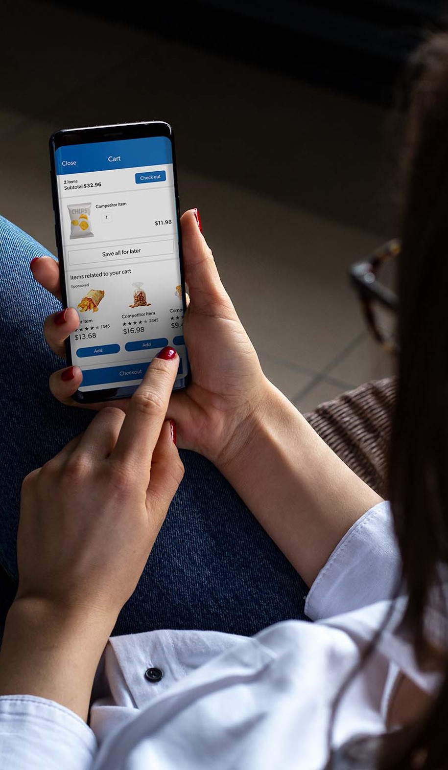 A member sits down with the Sam's Club app open on their mobile device.