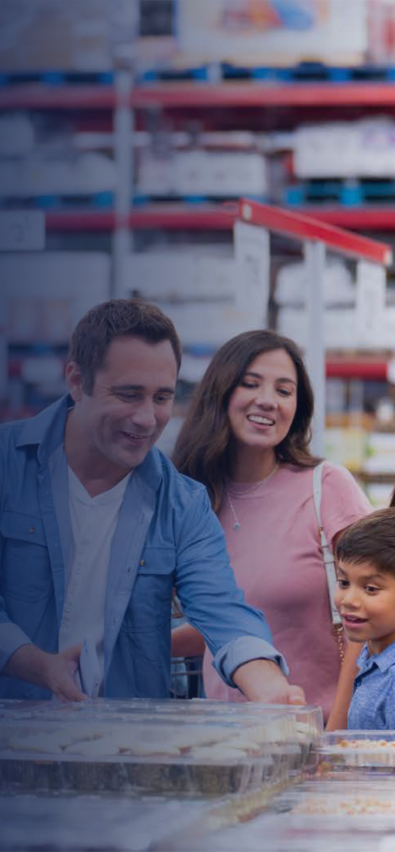 A family examines the shelves of items in a Sam's Club.