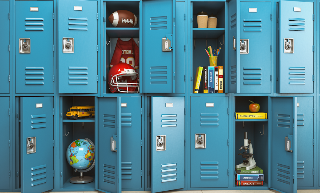 A row of school lockers filled with various school supplies such as books, a microscope, a globe, and a football uniform.