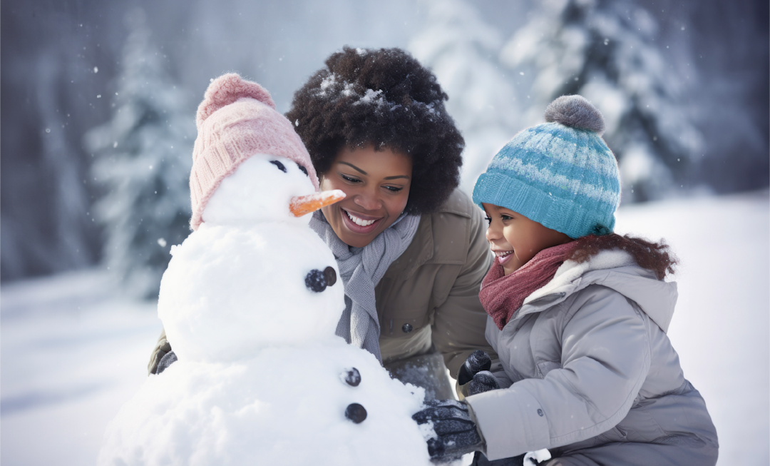 A woman and a child happily create a snowman together, surrounded by a snowy landscape.