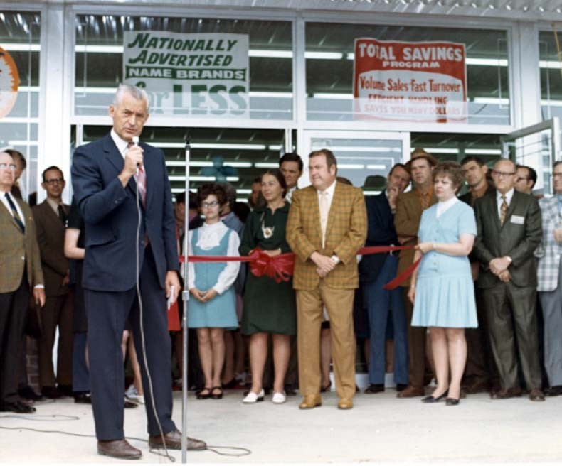 Sam Walton speaks at a red ribbon cutting ceremony.