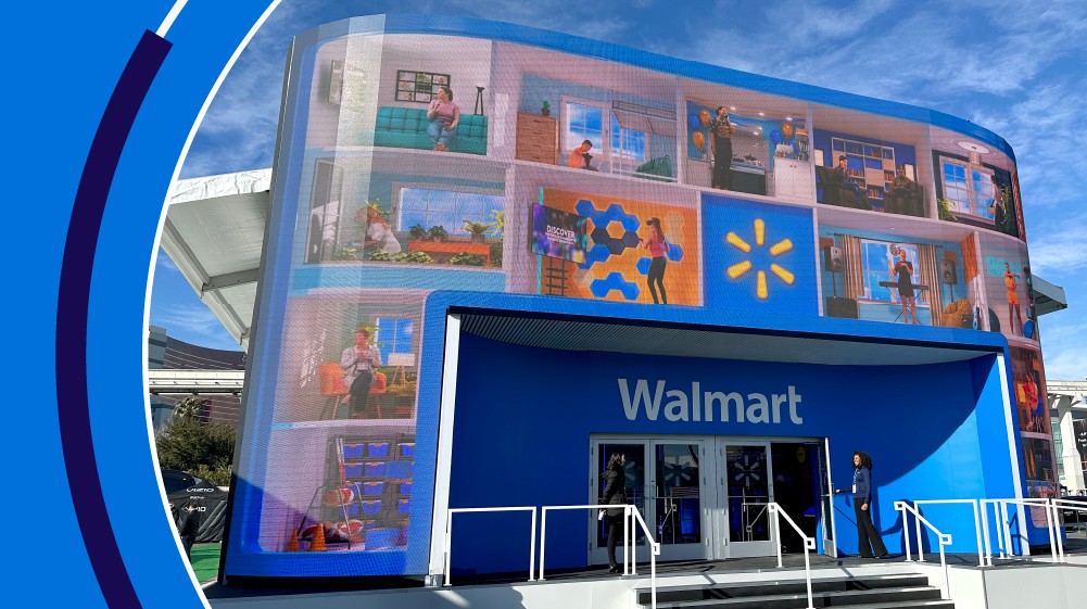 The image shows an inside view of the Walmart booth at CES 2024. There is a large Walmart logo.