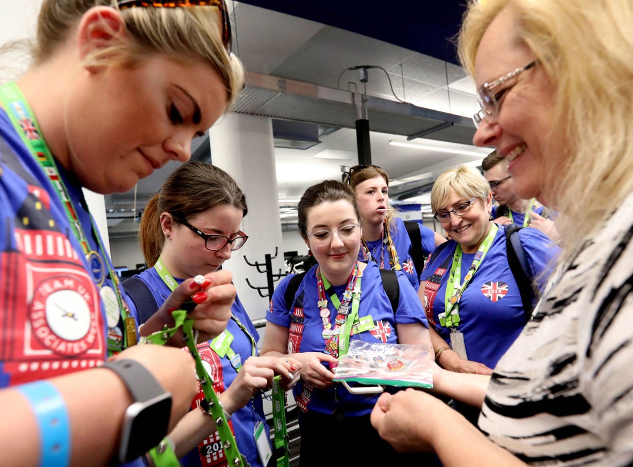 A group of international Walmart associates trade pins at Associates Week.