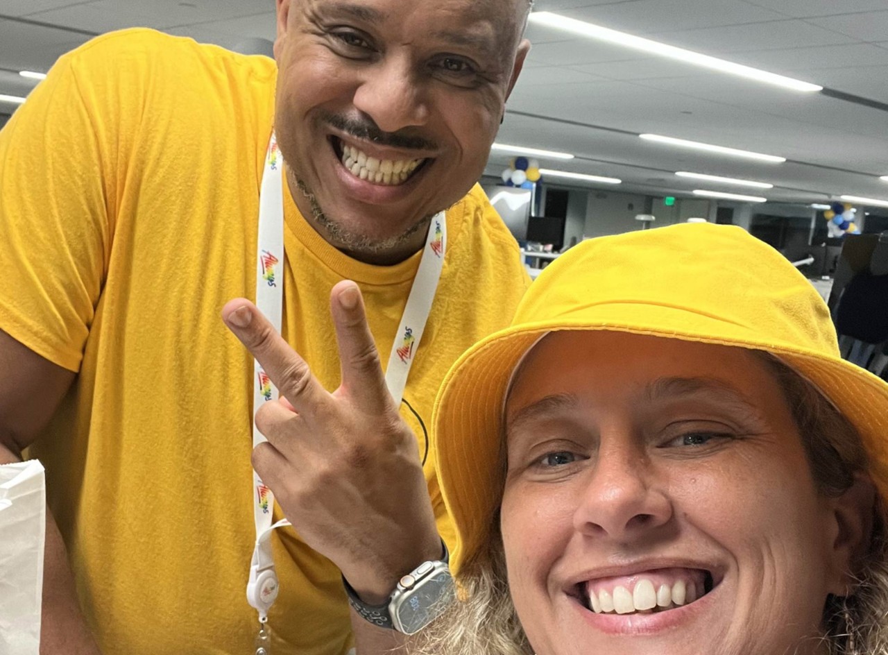Amber Lopez and Cedric Clark smile for a selfie while Cedric gives a peace sign at Walmart’s Associates Week 2024.